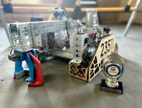 The team's Centerstage robot, with its 23511 number plate, beside a trophy