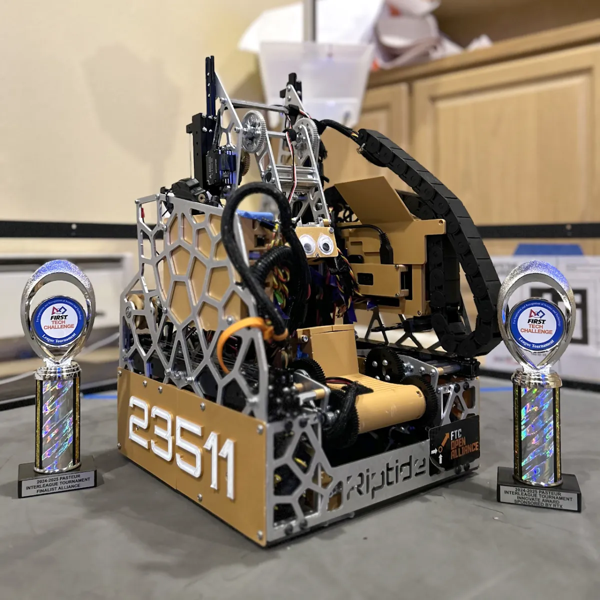 Riptide, the INTO THE DEEP robot, between its Pasteur Interleague Finalist Alliance and Innovate Award trophies