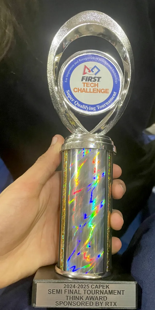 The 2024-25 Capek Semifinal Think Award trophy, held in a hand