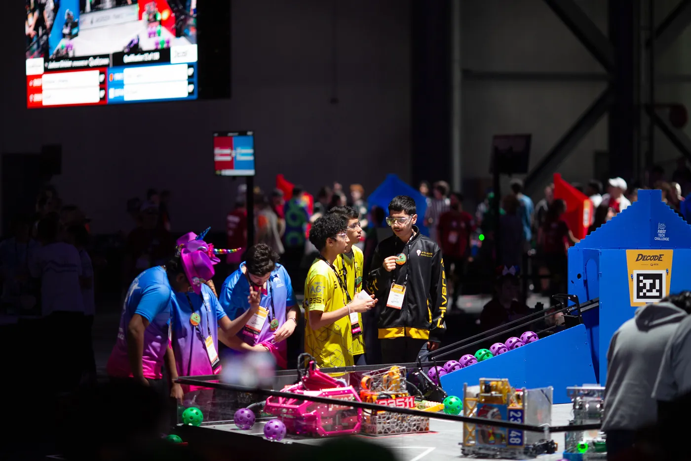 The Seattle Solvers drive team in yellow and black at the field edge in Houston, Cypher on the tiles in front of them