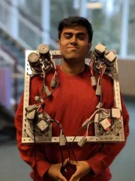 Aaditya holding a robot drivetrain frame