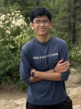 Aakarsh outdoors with his arms crossed