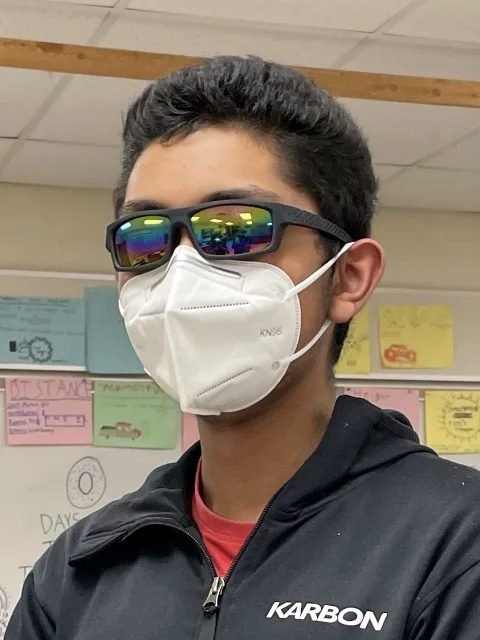 Anish wearing a mask and sunglasses